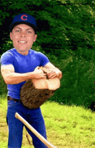 a man holding up a baseball on a baseball field