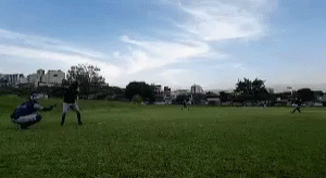 a couple people on a field playing frisbee