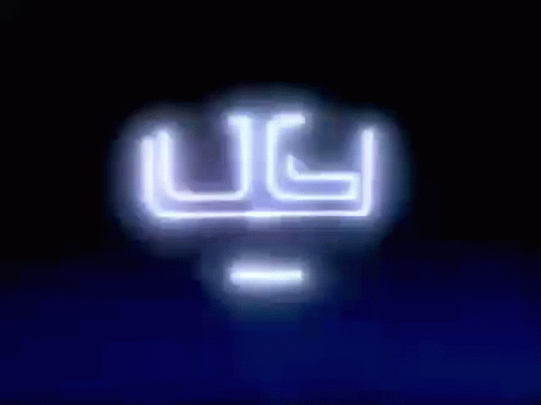 blurry image of the ugli neon sign on a building