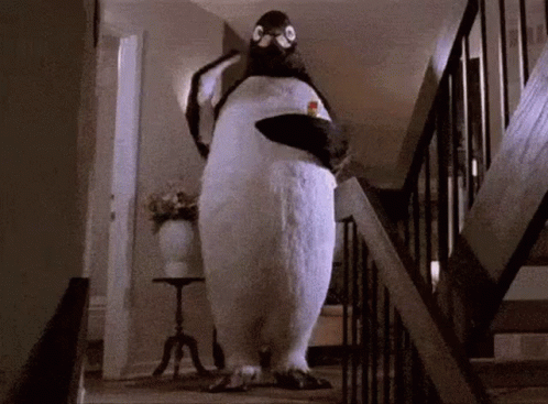 a penguin standing on top of a flight of stairs