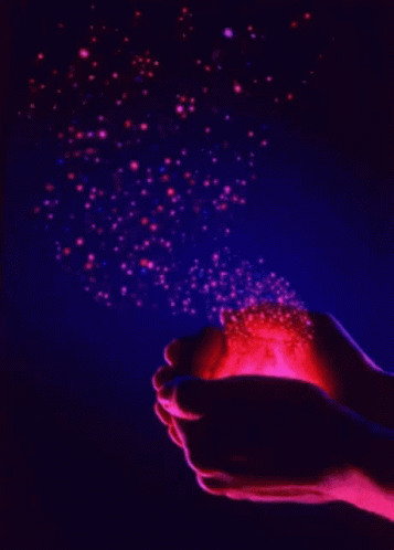 hands holding a blue and purple lit object