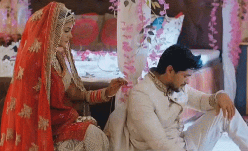 a bride and groom sitting on the floor