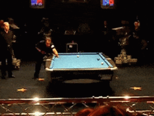 people playing with ping pong balls in an indoor event