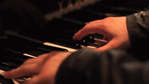 a person playing piano with their hands and fingers