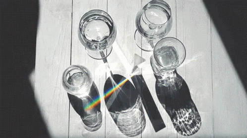 a group of glasses and a pair of baseball bats next to a rainbow