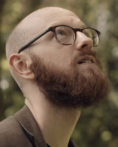 a person with a goatee wearing glasses