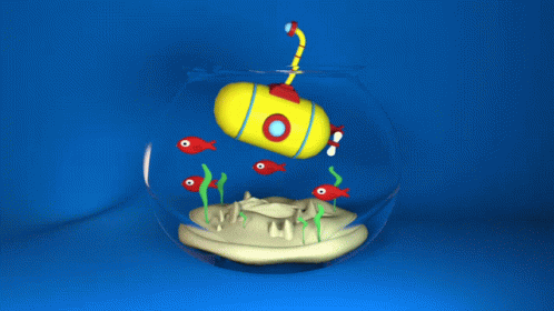 a fish in a bowl with a toy submarine