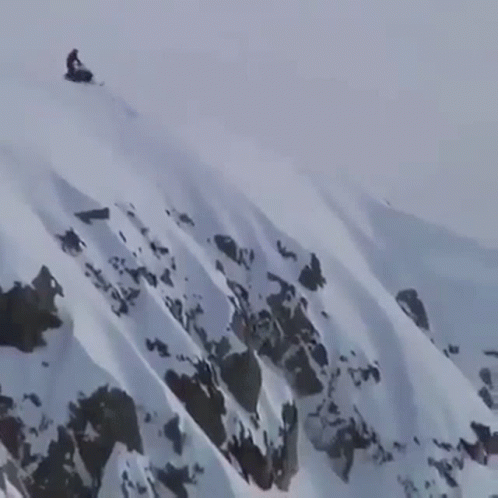 the man was in the mountains after a downhill snowbike