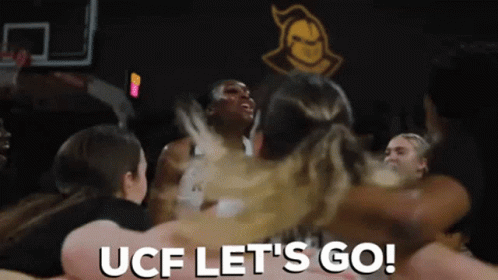a group of people on a dance floor with the text ucf let's go
