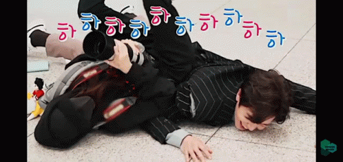 a man laying on the ground wearing all black