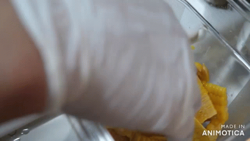 a hand dropping tissue from an industrial washing machine