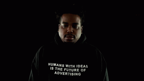a man in black hoodie with text written on it