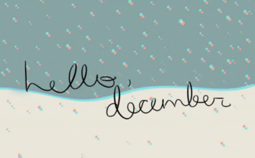 hello december written with black and white ink on a snow covered landscape