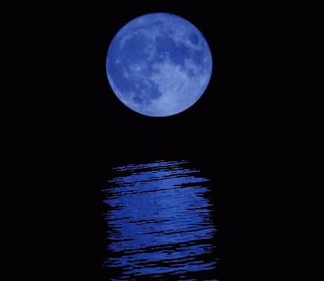 a bright moon reflecting on water with reflections