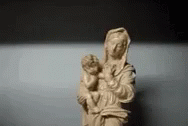 a small blue sculpture of a virgin holding a baby