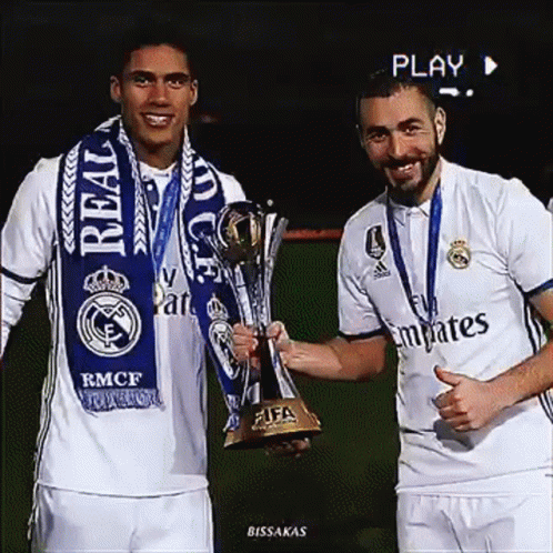 there are two men posing with a trophy