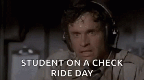 a man sitting next to a window with the caption student on a check ride day