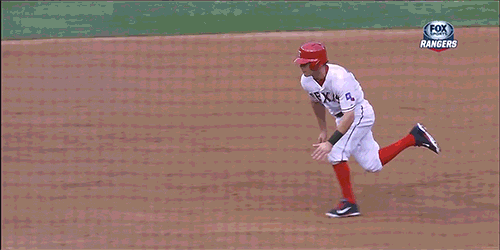 a man in a baseball uniform runs across the field