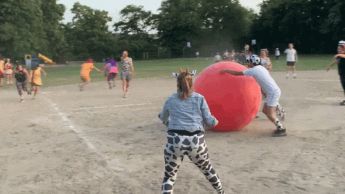 people in the background playing with a large ball