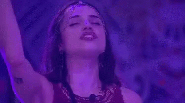 a girl singing into the air with a red background