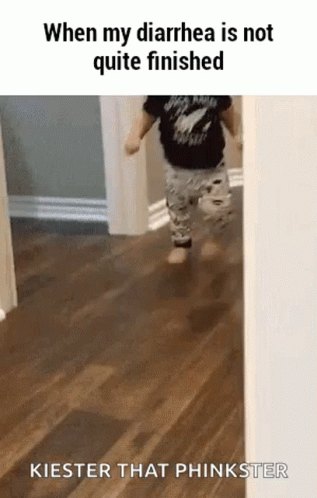 a child walking in a hallway wearing an upside down black shirt