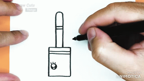 a person writing on paper next to a small ink pen