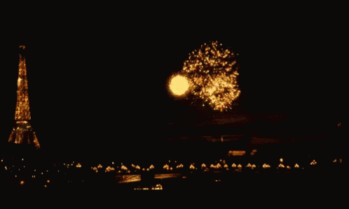 fireworks are lit in the air near a tall tower