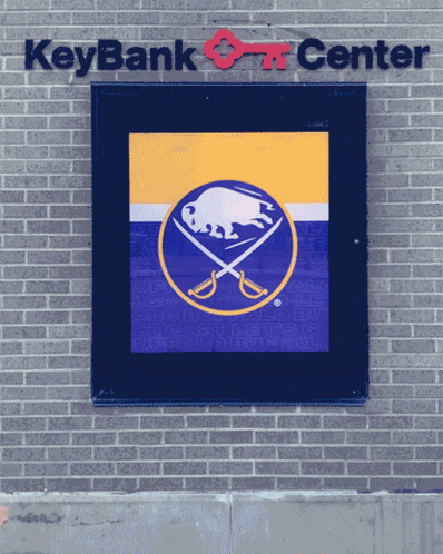 a wall mounted sign above a sign that says key bank art center