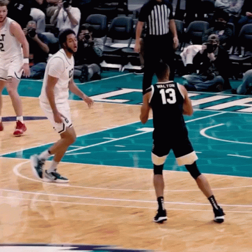 two basketball players playing ball on the court