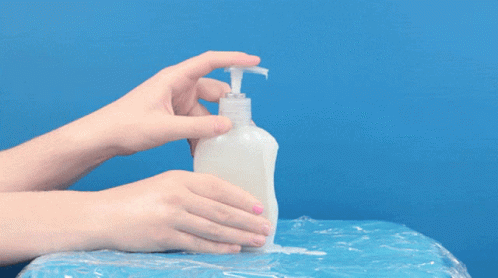 a hand reaching into a bottle of soap
