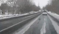 the cars are driving down a snowy street
