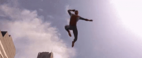 a man is jumping in the air from a high rise with clouds coming out