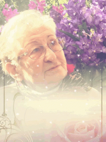 an old woman is shown next to pink flowers
