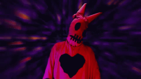 this is a man in a purple devil costume with a heart