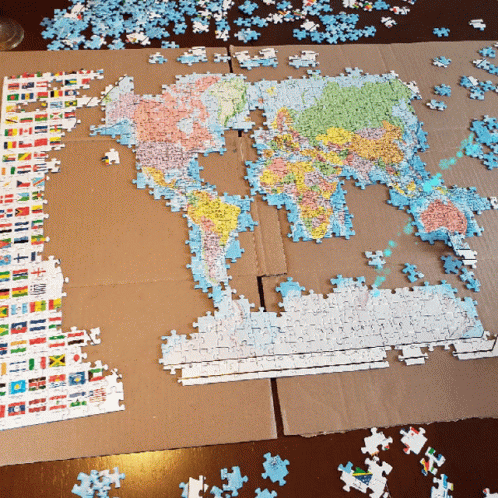 this is the puzzle pieces of a world map on a table