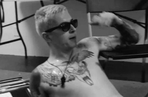 a man with his tattoos and sunglasses on