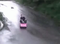 a woman riding in an upside down toy truck