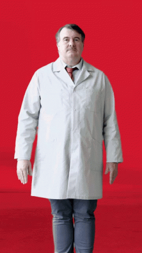 a man standing on one foot wearing a white lab coat