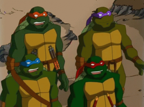 three teenaged turtles are standing next to each other