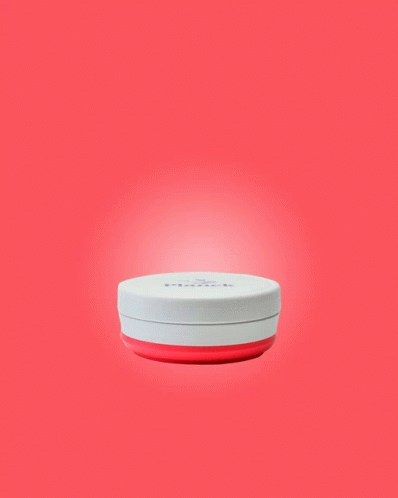 a white, round, portable device with a light coming from the top