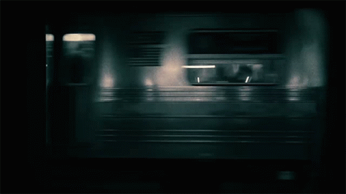 a blurry po of a train moving in to a station
