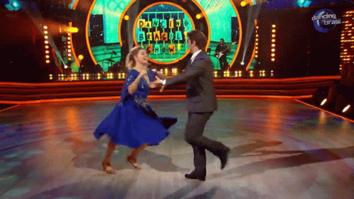 a man and woman dancing on stage on tv