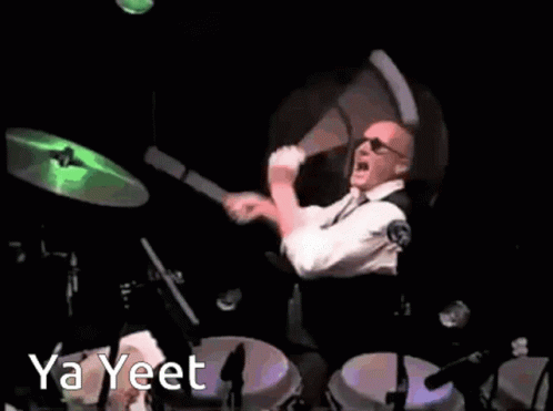 a man is playing drums with a light green ball in the background