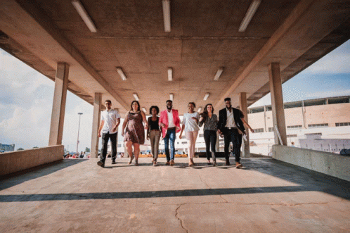 a group of people walking underneath an overpass