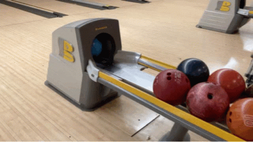 bowling lanes with many different colored bowling balls