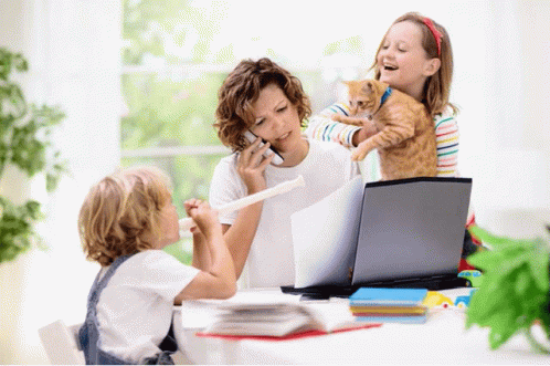 children sit around a computer screen laughing at soing