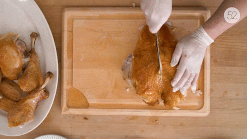 the chicken is being cut into pieces with a knife