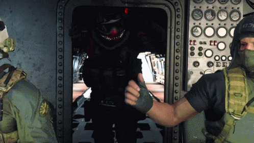 two men in protective gear standing inside a space station