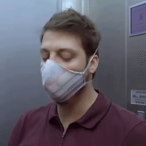 the man is wearing a face mask to help keep him on his side