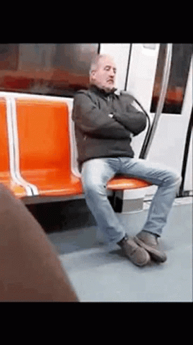 a person sitting on the bench in the train